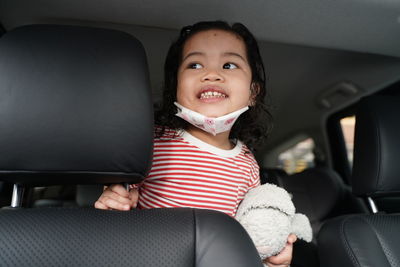 Portrait of girl sitting in car