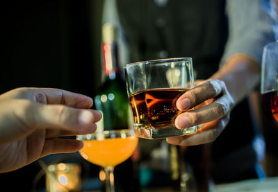 Close-up of hand holding beer glass