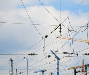 Low angle view of electricity pylon against sky