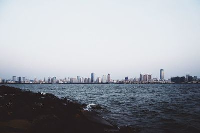 Sea with cityscape in background