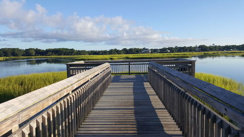 Pier over lake against sky