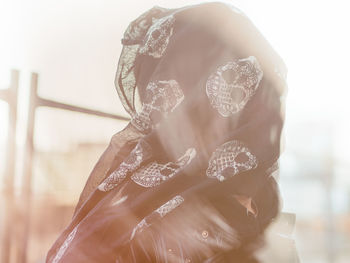 Close-up of woman face covered with scarf outdoors