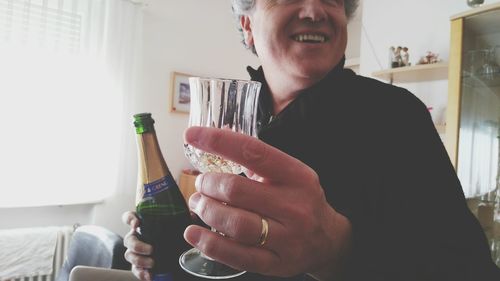 Close-up of man holding ice cream at home