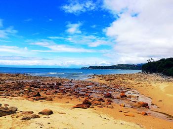 View of beach against cloudy sky