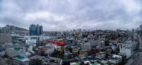 High angle view of city buildings against sky