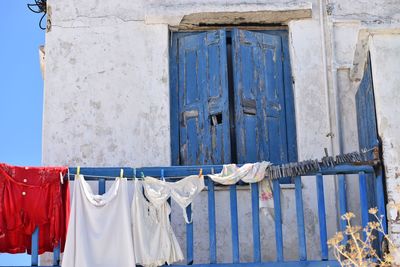 Clothes drying against blue wall of building,mykonos, greece 