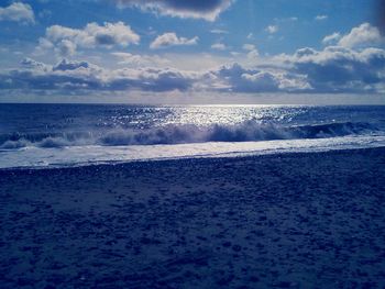 Scenic view of sea against cloudy sky