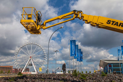 Low angle view of ferris wheel against sky
