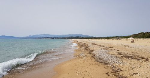 Scenic view of beach against clear sky