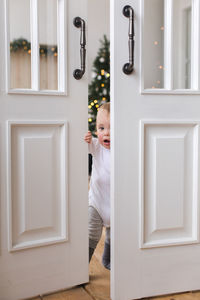 Charming kid opens the door and is surprised