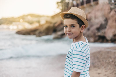 Portrait of smiling boy standing on beach