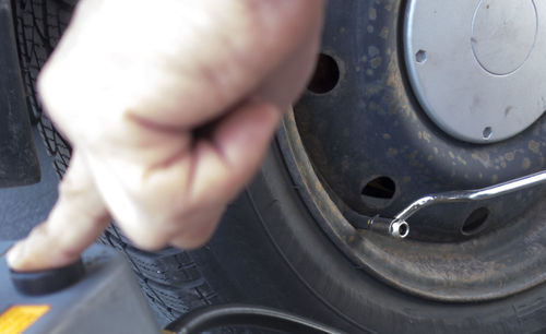 Checking the tire inflation pressure of a car and inflate tire with air