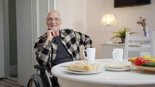 Portrait of senior man eating breakfast