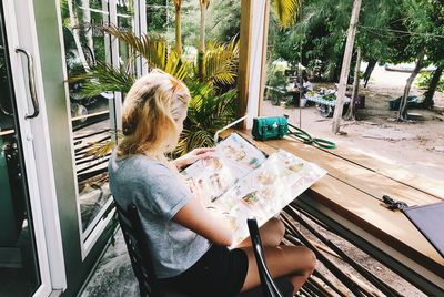 Woman reading menu while sitting at restaurant