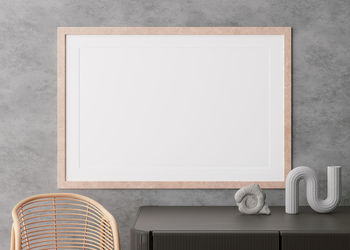 Empty horizontal picture frame on concrete wall in modern living room. mock up interior 