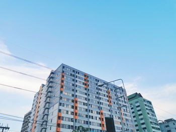 Low angle view of modern buildings against clear blue sky