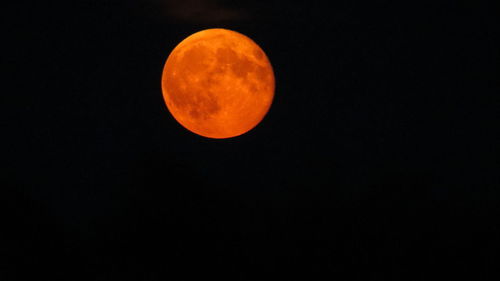 Low angle view of moon against clear sky at night