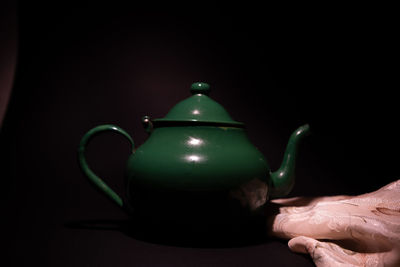 Close-up of tea cup against black background