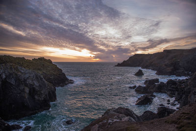 Scenic view of sea against sky during sunset at kynance cove