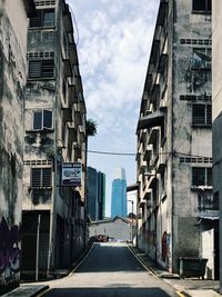 Road amidst buildings against sky in city