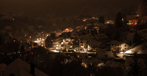 High angle view of houses in town at night