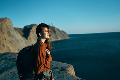 Man looking at sea against sky