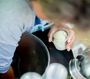 High angle view of man serving ice cream in glass at market