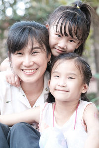Portrait of happy mother smiling and two daughters 