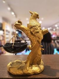 Close-up of angel statue on table