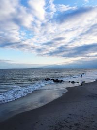 Scenic view of sea against cloudy sky