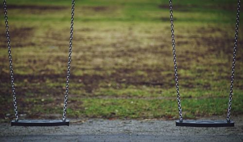 Close-up of empty swings in park