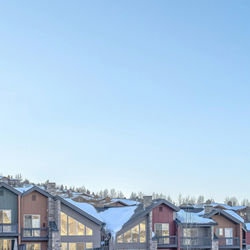 Buildings in city against clear sky