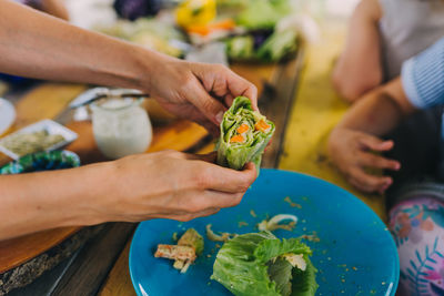 Cropped image of woman holding food