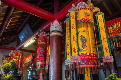 Low angle view of illuminated lanterns hanging outside building