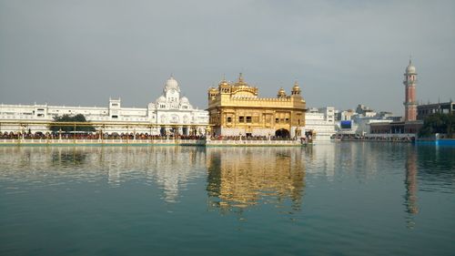 Buildings at waterfront against sky