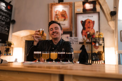 Portrait of smiling man with drink