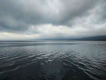 Scenic view of sea against storm clouds