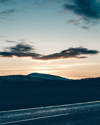 Scenic view of silhouette mountain against sky at sunset