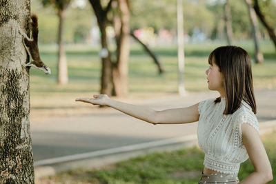 Side view of woman standing on field