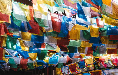 Full frame shot of multi colored prayer flags hanging outdoors