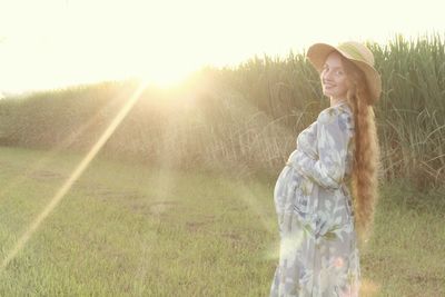 Woman standing on field against sky