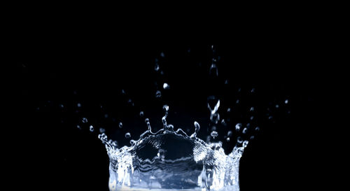 Close-up of water splashing against black background