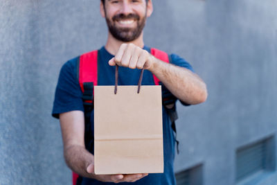 Man holding camera while standing in box