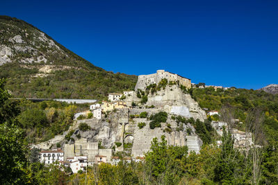 Buildings against clear blue sky