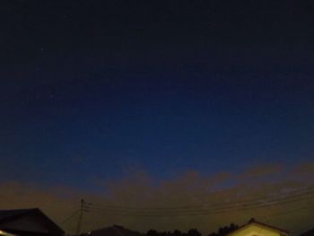 Low angle view of silhouette building against sky at night