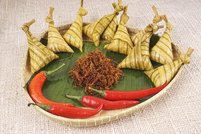 High angle view of chili peppers and leaves on table