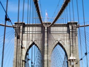 Low angle view of brooklyn bridge against blue sky