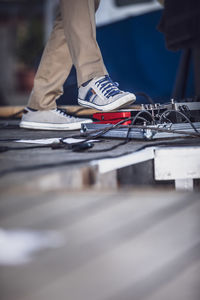 Low section of man standing on floor in city