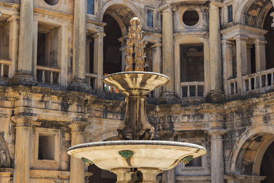 Low angle view of fountain against historic building