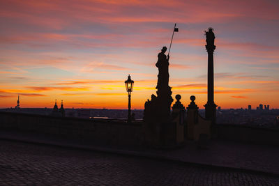 Silhouette of building against sky during sunset